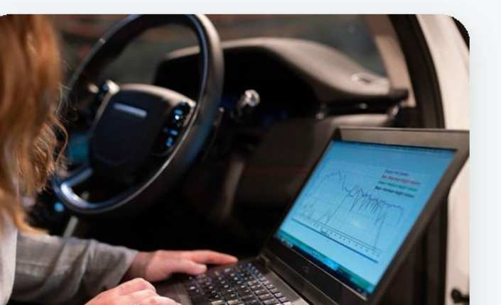A field-service worker using a laptop in a vehicle