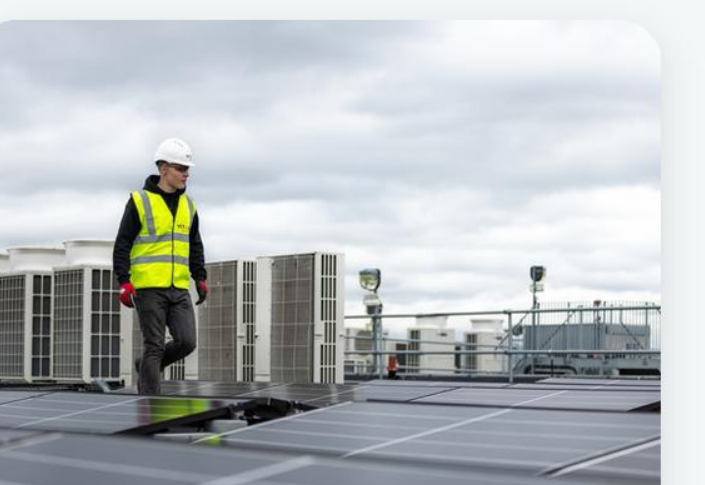 A maintenance technician working on a commercial rooftop